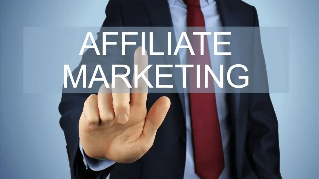 A person in a suit touching a graphic that says ‘affiliate marketing.’